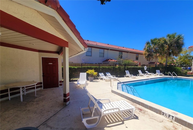 view of swimming pool with a patio area