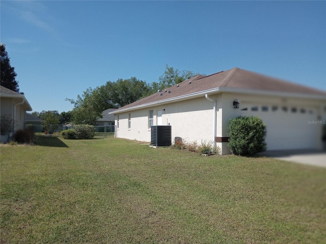 view of side of home featuring central air condition unit and a lawn