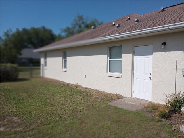 view of side of property with a lawn