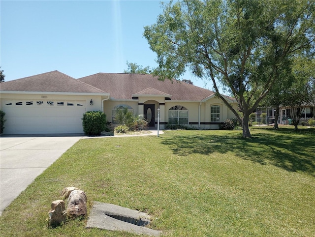 ranch-style home featuring a garage and a front yard