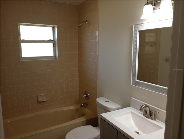 full bathroom with tiled shower / bath combo, vanity, and toilet