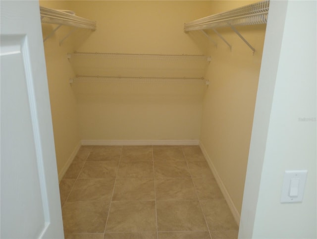 walk in closet featuring tile flooring