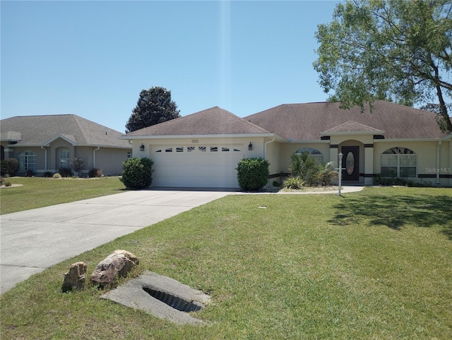 ranch-style home featuring a garage and a front lawn