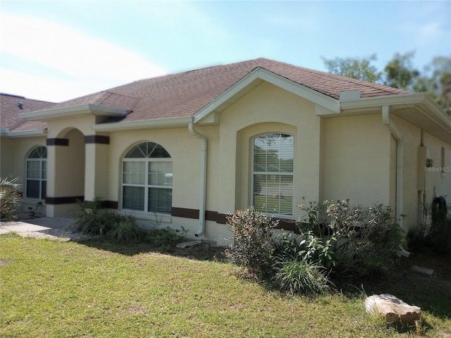 view of side of home with a lawn