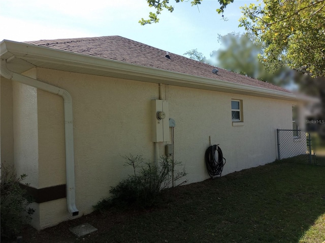 view of side of home with a yard