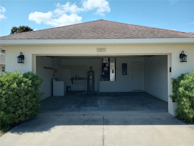 garage with water heater, heating utilities, and washer / clothes dryer