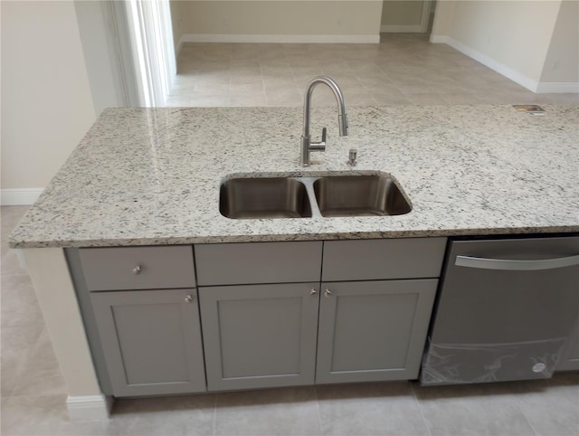 interior details featuring sink, light tile flooring, and stainless steel dishwasher