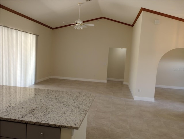 spare room with a wealth of natural light, ceiling fan, light tile floors, and lofted ceiling