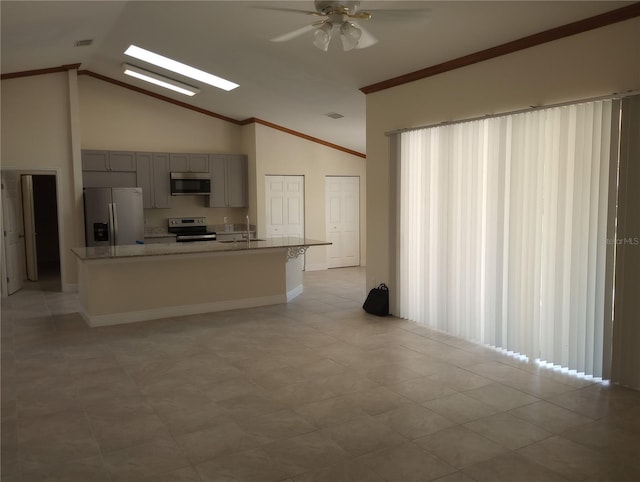 kitchen featuring high vaulted ceiling, ceiling fan, stainless steel appliances, an island with sink, and light tile floors