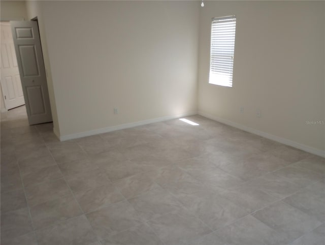 spare room featuring light tile flooring