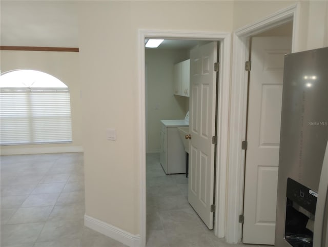 hall featuring washer and dryer and light tile floors