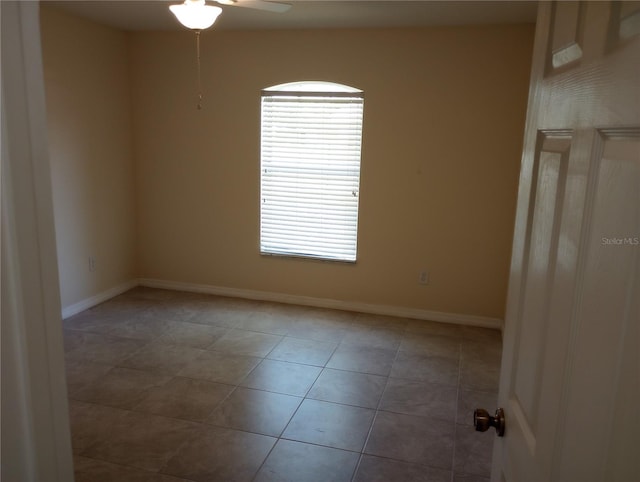 tiled spare room with ceiling fan and a healthy amount of sunlight