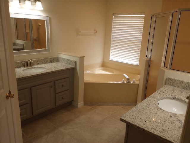 bathroom with tile flooring, vanity, and separate shower and tub