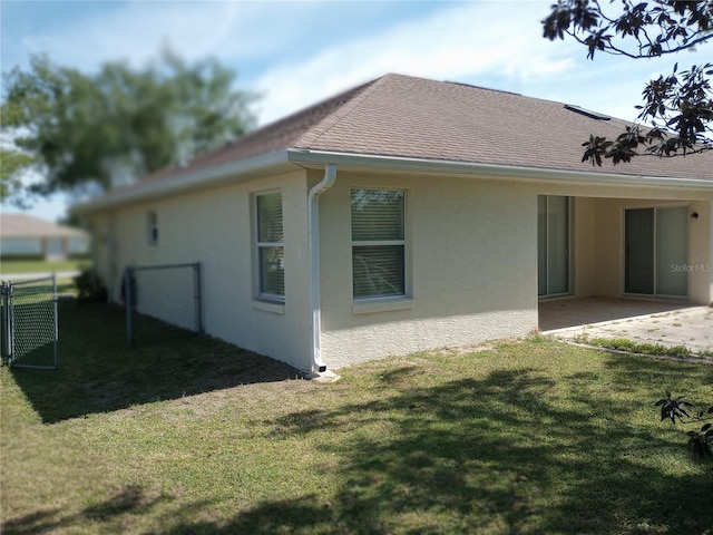 back of property with a patio area and a lawn