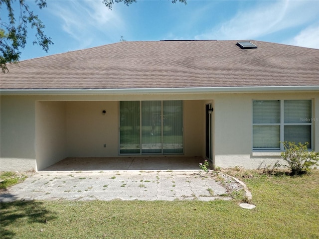 rear view of house featuring a yard and a patio area