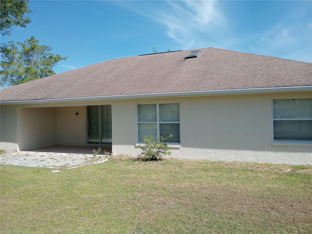 back of house with a lawn