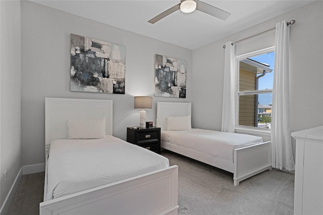 carpeted bedroom with ceiling fan and multiple windows