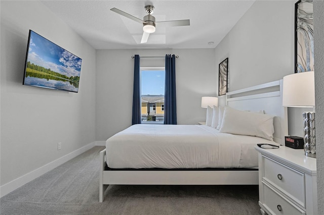 bedroom with dark colored carpet and ceiling fan