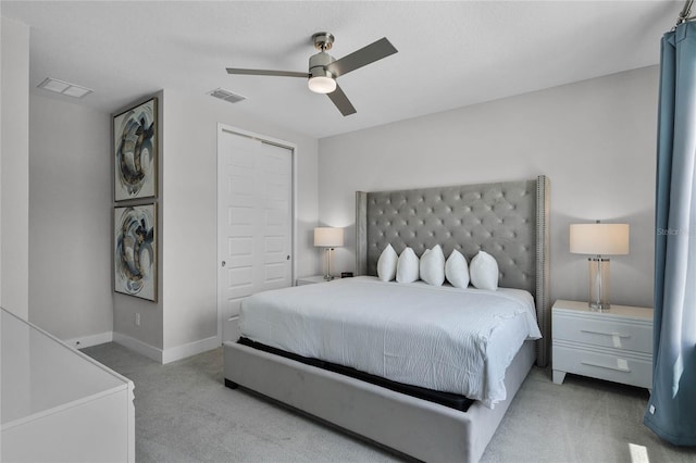 bedroom featuring light colored carpet, a closet, and ceiling fan