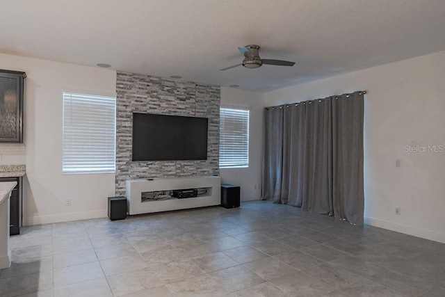 unfurnished living room with ceiling fan and light tile floors