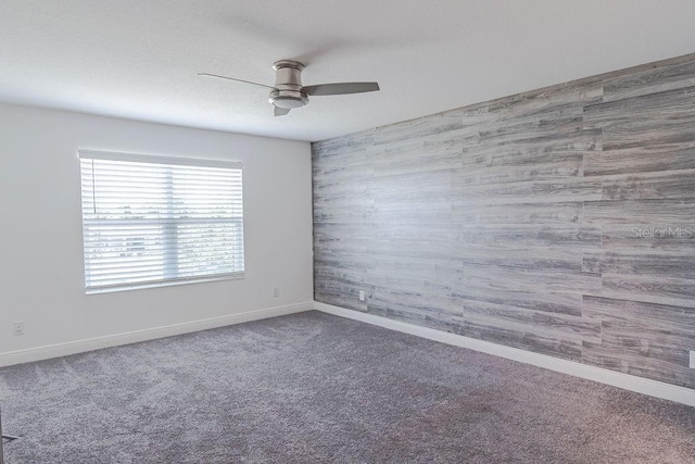 spare room with ceiling fan and carpet flooring