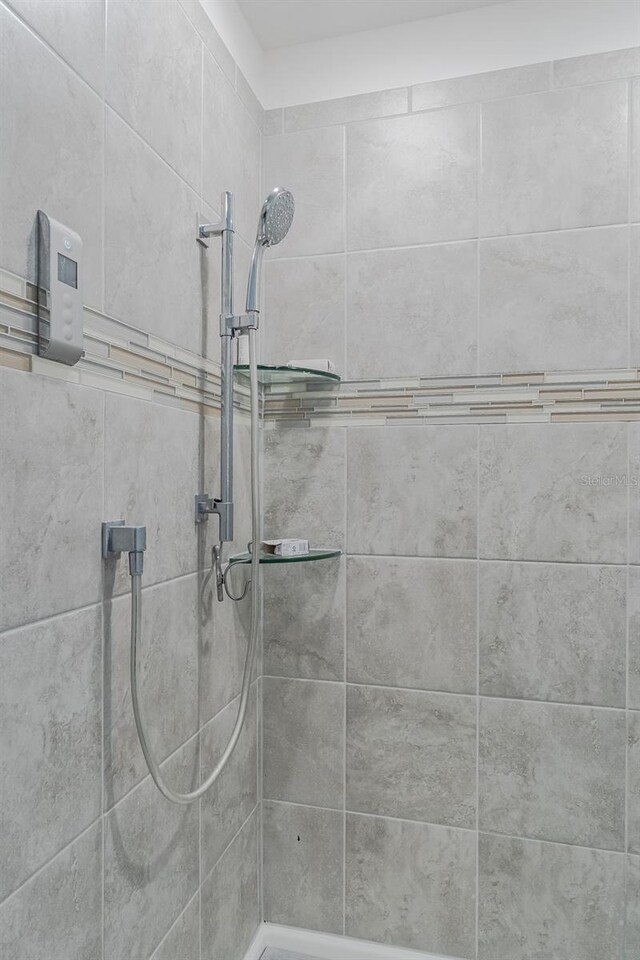 bathroom with a tile shower