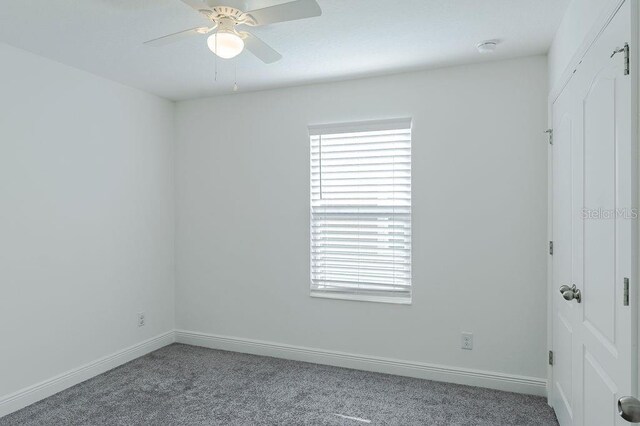 spare room with ceiling fan and carpet floors