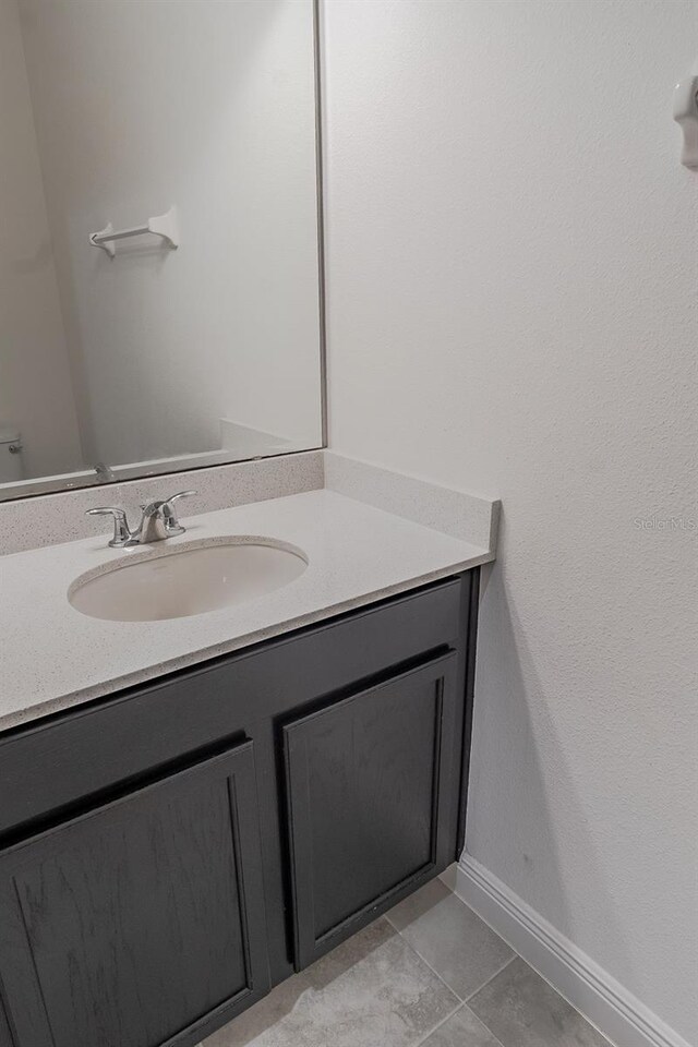 bathroom featuring tile flooring and vanity