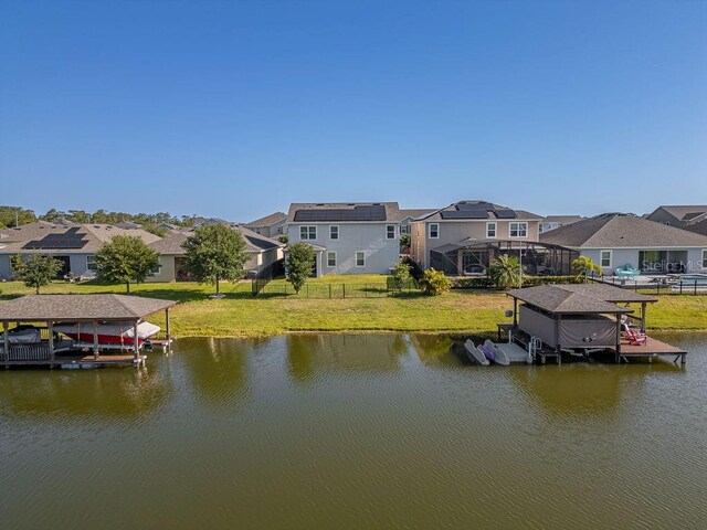 view of dock featuring a water view and a lawn