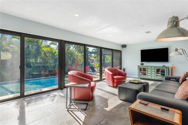 living room featuring a wealth of natural light and tile flooring