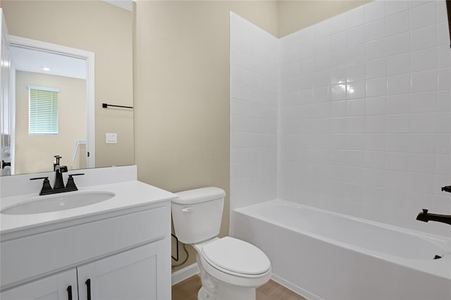 full bathroom featuring tiled shower / bath, vanity, and toilet