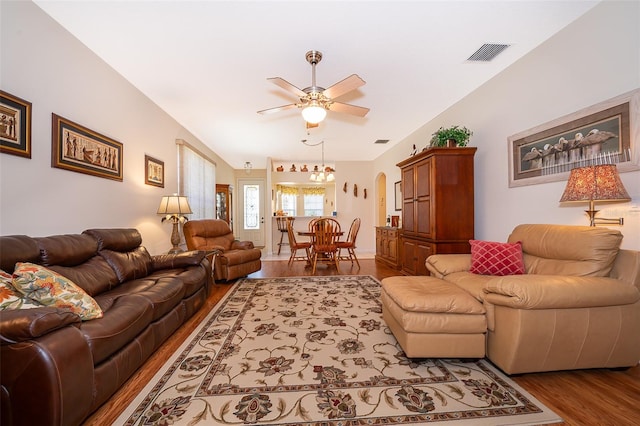 living room featuring ceiling fan and dark hardwood / wood-style floors