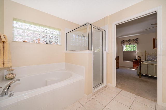 bathroom with tile flooring, ceiling fan, and plus walk in shower