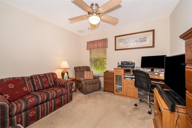 home office with ceiling fan and light carpet