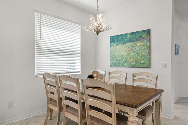 dining space with a chandelier and light tile floors