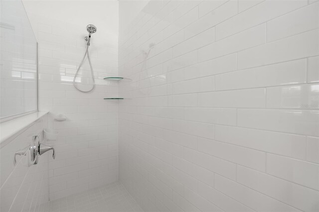 bathroom with a tile shower