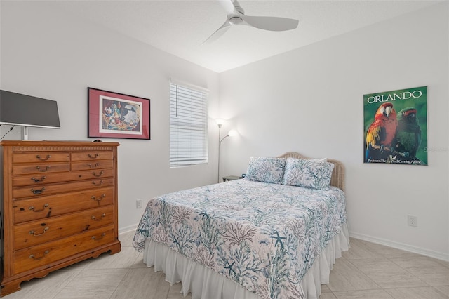 bedroom featuring ceiling fan and tile floors