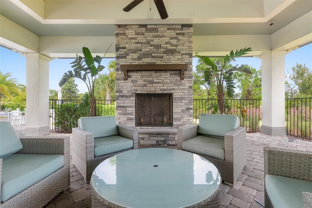 view of patio featuring an outdoor living space with a fireplace and ceiling fan