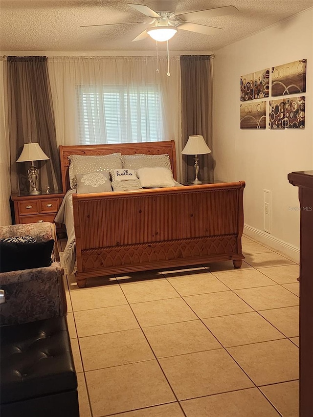 tiled bedroom with ceiling fan and a textured ceiling