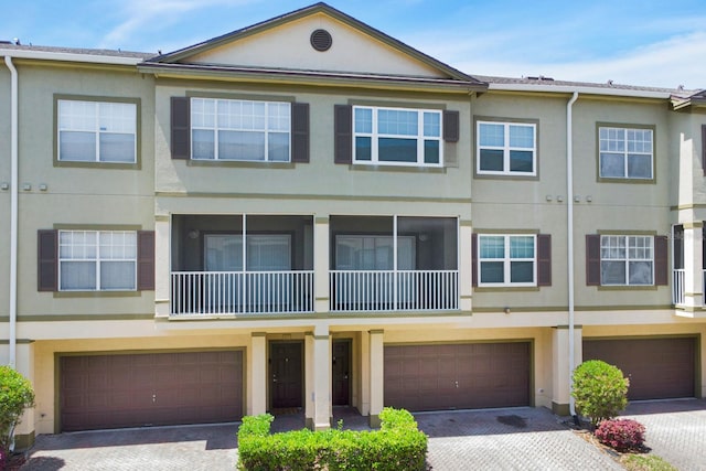 townhome / multi-family property featuring a garage and a balcony