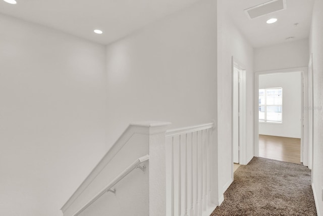 hallway featuring light colored carpet