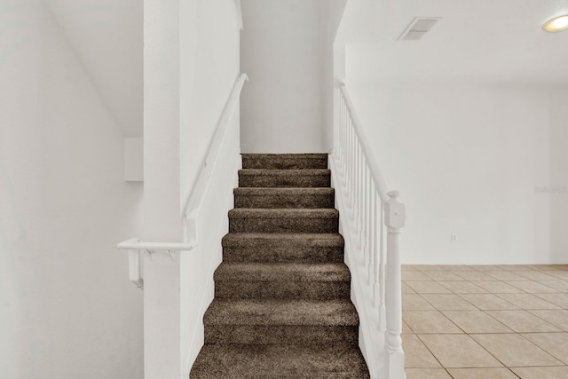 staircase with light tile floors