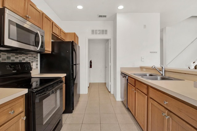 kitchen with sink, backsplash, stainless steel appliances, and light tile floors