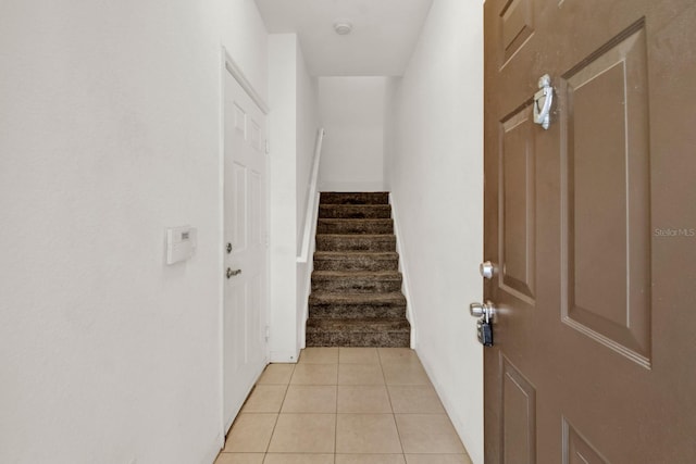 stairway with light tile floors