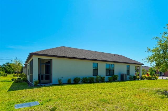 rear view of property featuring a yard