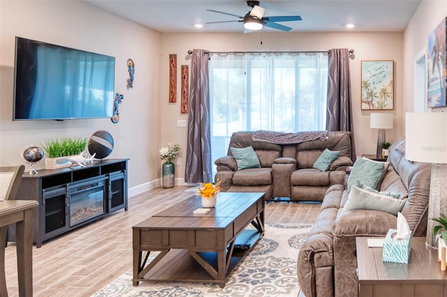 living room featuring light hardwood / wood-style floors and ceiling fan