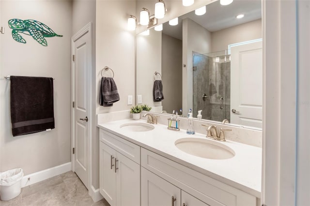 bathroom with tile flooring, dual sinks, oversized vanity, and walk in shower