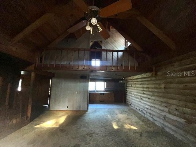 interior space with dark colored carpet and ceiling fan