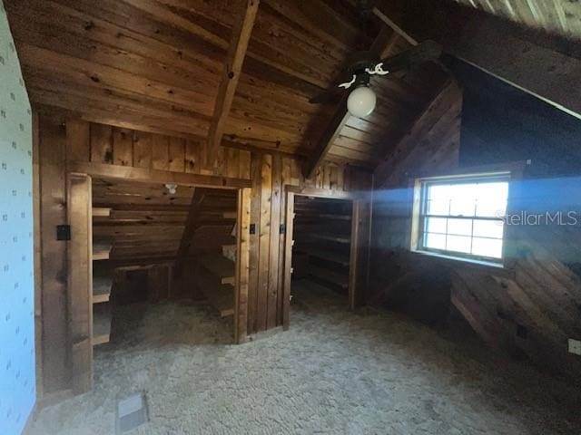 interior space with wood ceiling, lofted ceiling, and dark carpet