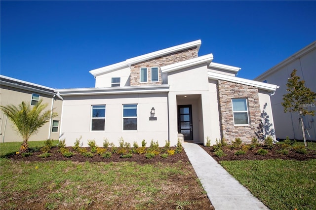 contemporary house featuring a front yard